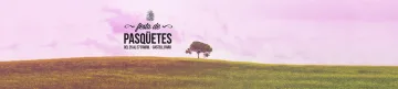 Rètol sobre un prat: «Festa de Pasqüetes · Del 25 al 27 d'abril · Castell d'Aro».